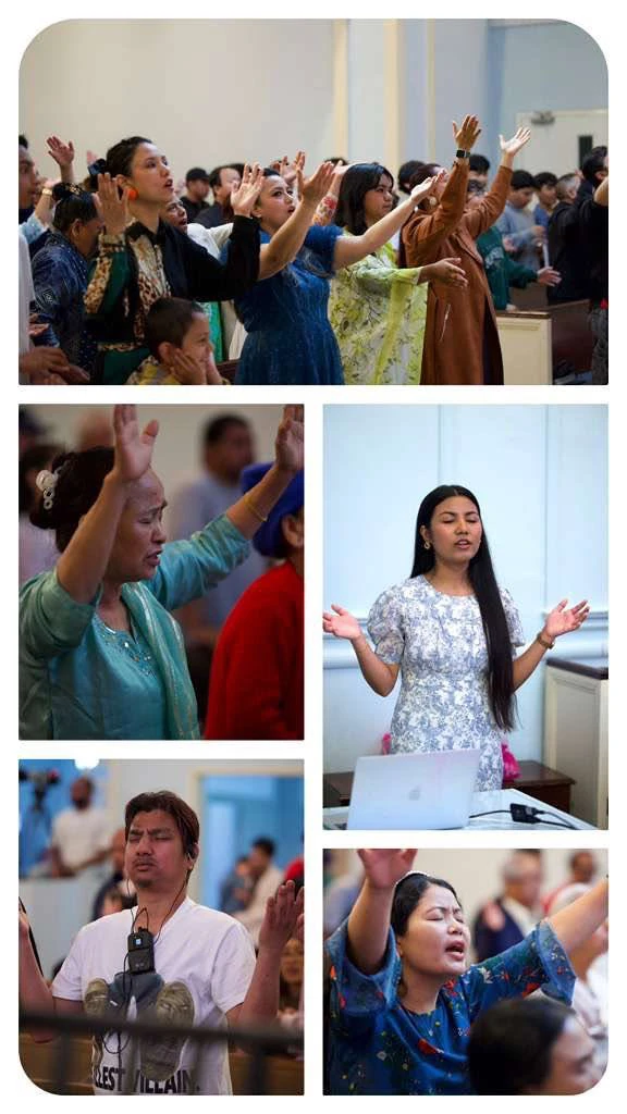 Congregation in worship with hands raised